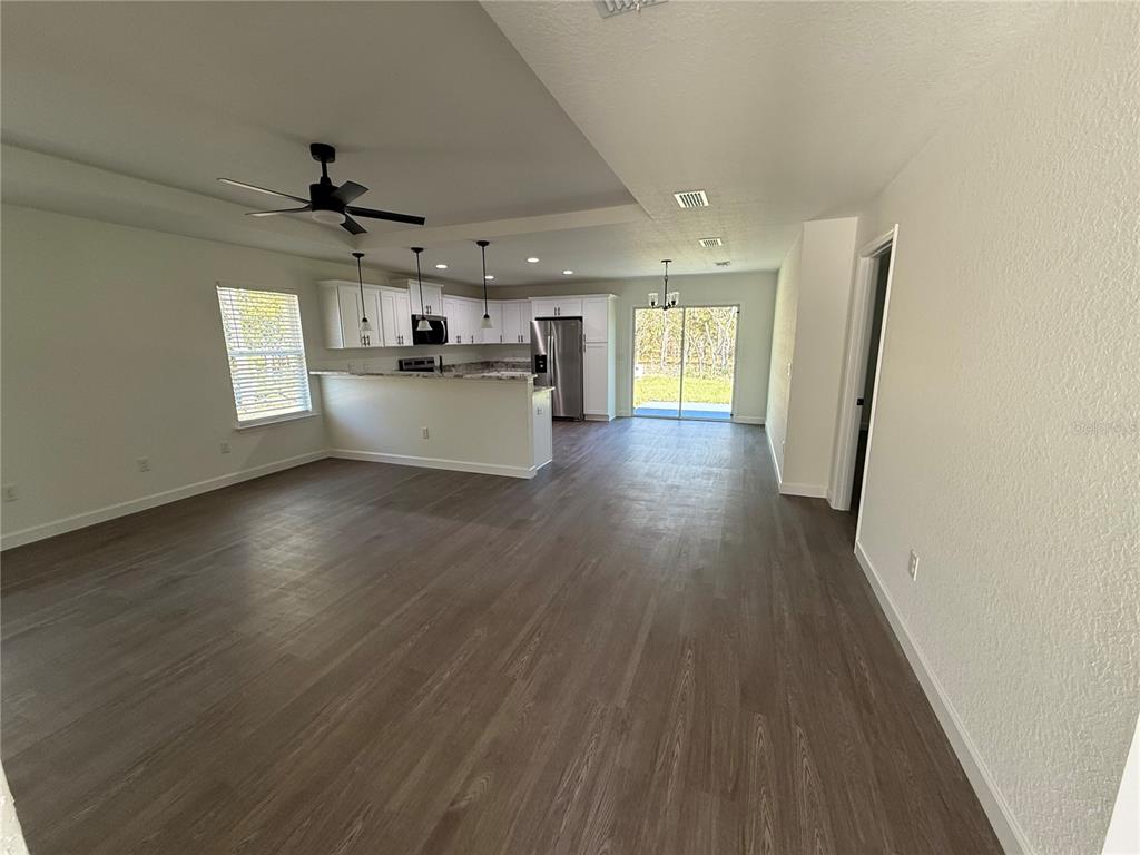 649 Southwest Winding Hills Road Dunnellon, FL 34431 - Photo 3 of 26 a view of a kitchen with a sink wooden floor and a window