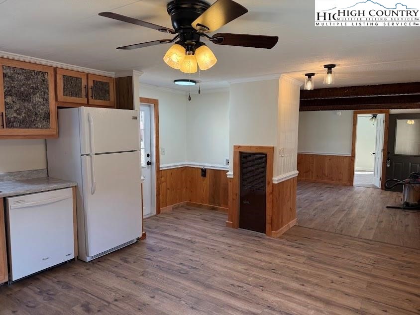 388 Monroe Miller Road Lansing, NC 28643 - Photo 16 of 34 a kitchen with a refrigerator a stove top oven a counter space and wooden floor