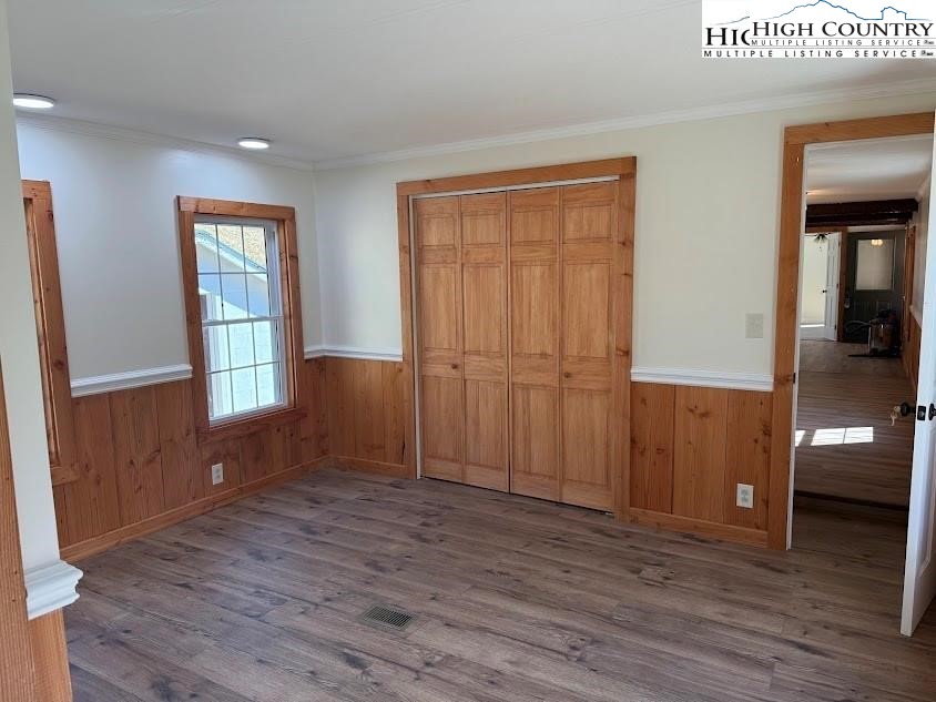 388 Monroe Miller Road Lansing, NC 28643 - Photo 19 of 34 an empty room with wooden floor and windows