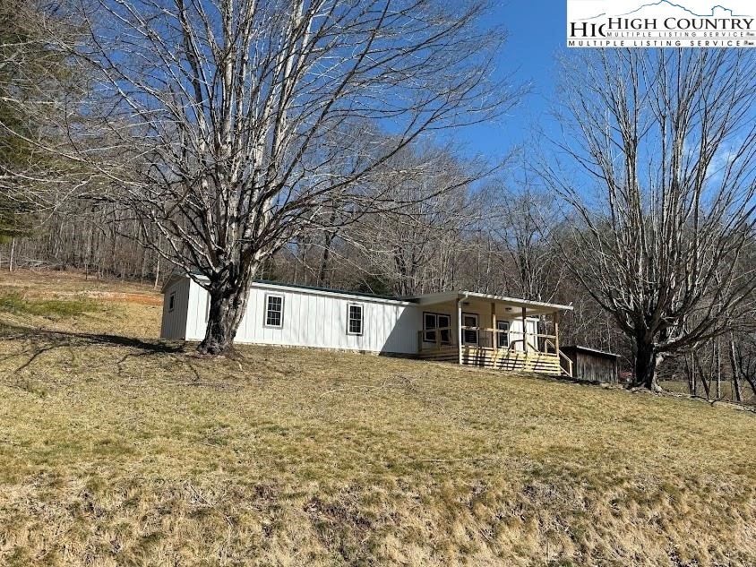 388 Monroe Miller Road Lansing, NC 28643 - Photo 2 of 34 a white house that has a tree in front of it