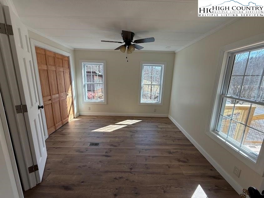 388 Monroe Miller Road Lansing, NC 28643 - Photo 23 of 34 wooden floor in an empty room with a window