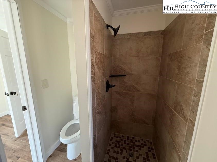 388 Monroe Miller Road Lansing, NC 28643 - Photo 27 of 34 a bathroom with a shower toilet and sink