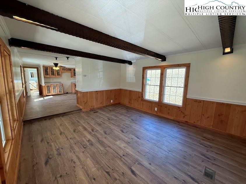388 Monroe Miller Road Lansing, NC 28643 - Photo 9 of 34 a view of empty room with wooden floor and fan