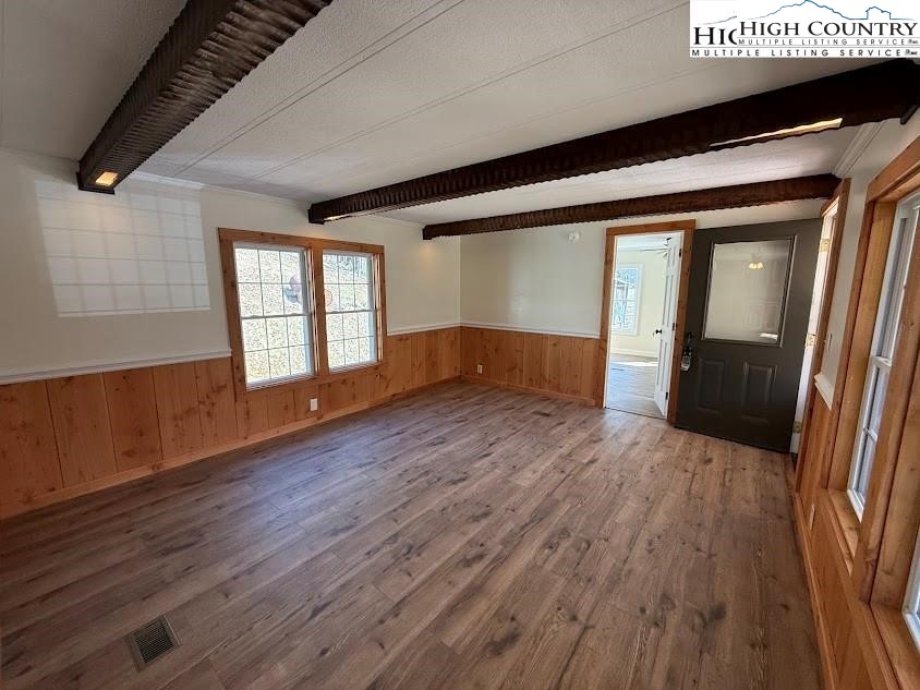 388 Monroe Miller Road Lansing, NC 28643 - Photo 10 of 34 wooden floor in an empty room with a window