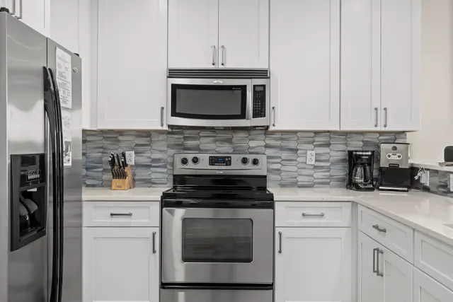 a kitchen with cabinets stainless steel appliances and a sink