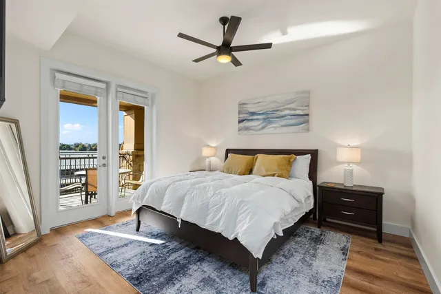 a bedroom with a bed bookshelf and a window