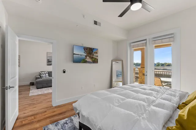 a bedroom with a bed and a large window