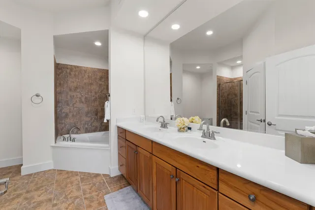 a bathroom with a sink a bathtub and a mirror