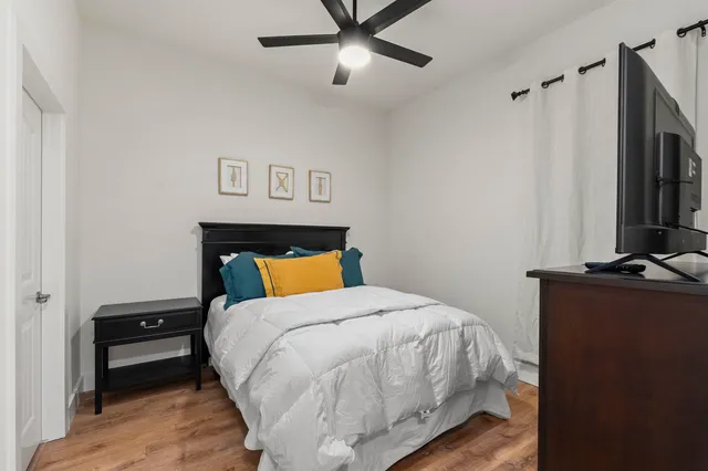a bedroom with a bed and wooden floor