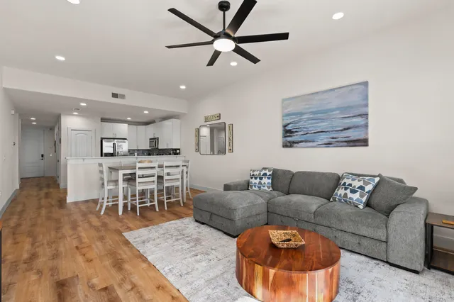 a living room with furniture and a dining table