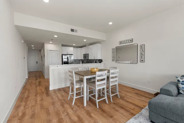 a dining room with furniture and wooden floor