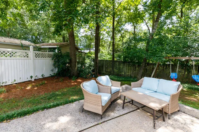 a view of backyard with furniture and plants