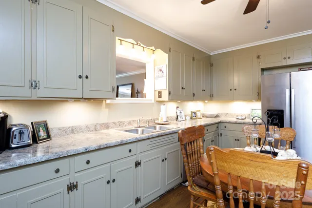 a kitchen with a sink refrigerator and cabinets