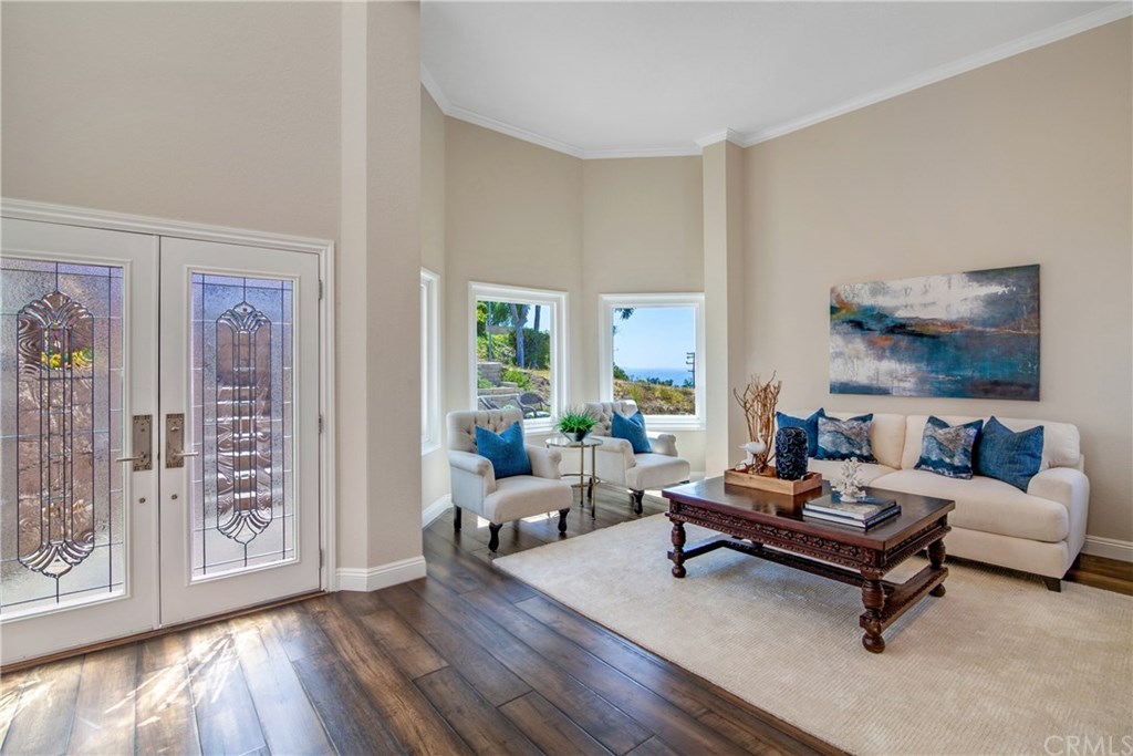 Beautiful leaded glass doors and wood framed windows allow plenty allow light and ocean view.