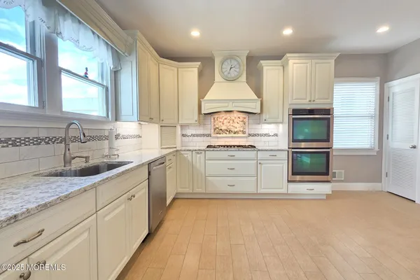 a living room with a fireplace a flat screen tv and a window