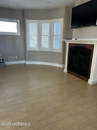 a view of wooden floor and windows in a room