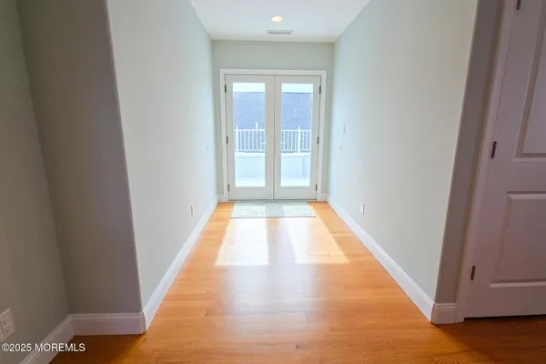 a living room with furniture a flat screen tv and a window