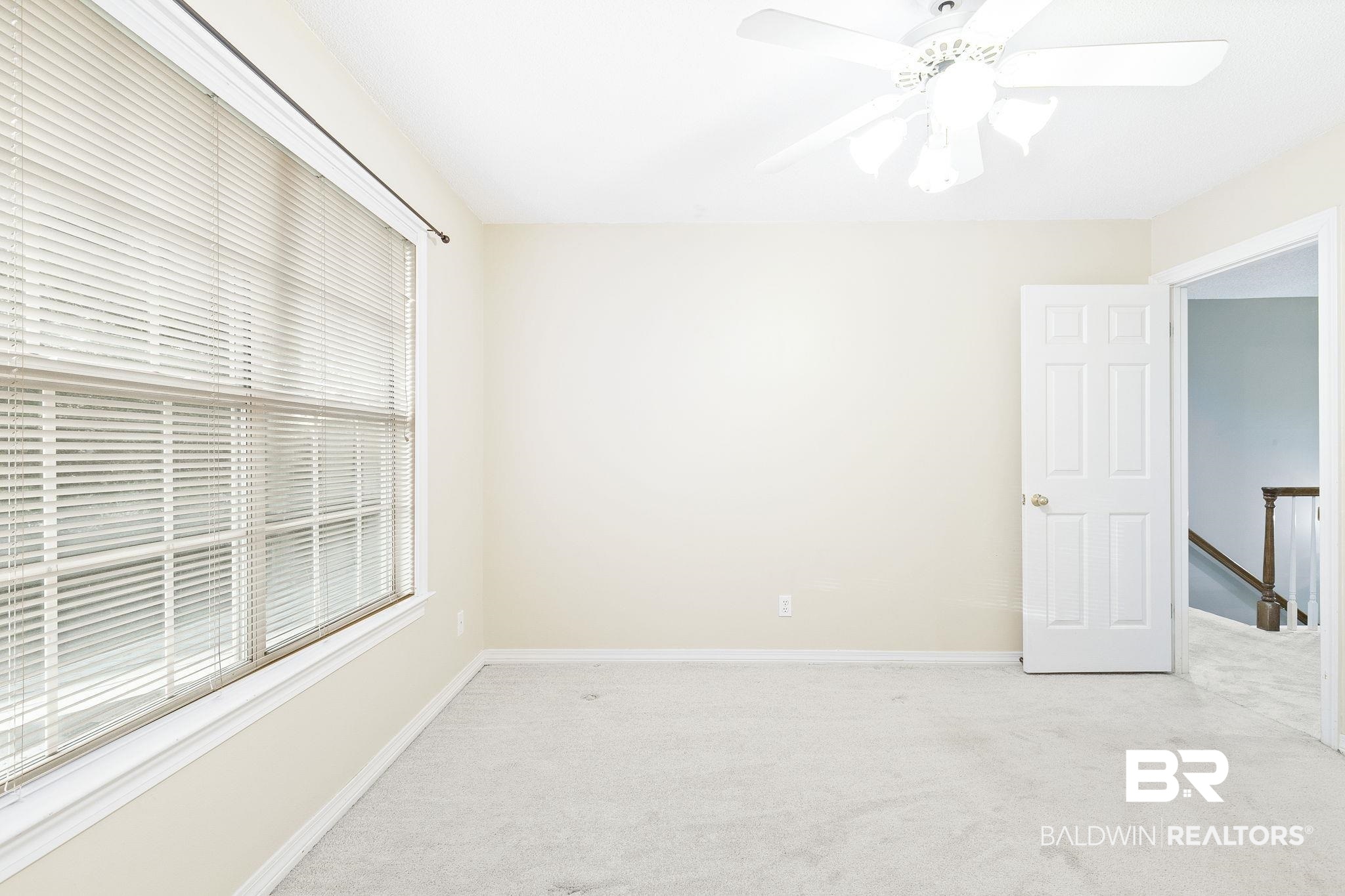 2100 Stonebrook Drive West Mobile, AL 36695 - Photo 40 of 60 Unfurnished room with a healthy amount of sunlight, ceiling fan, and light colored carpet