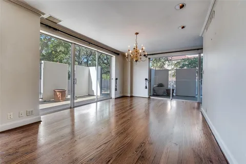 a view of a livingroom with wooden floor and a large window