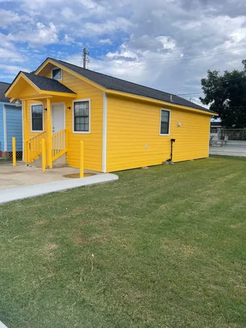 a front view of a house with a big yard
