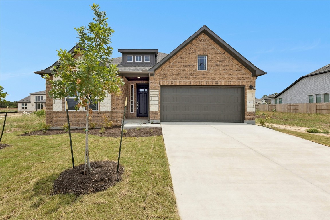 161 Smithsonian Lane Kyle, TX 78640 - Photo 1 of 1 a front view of a house with garden