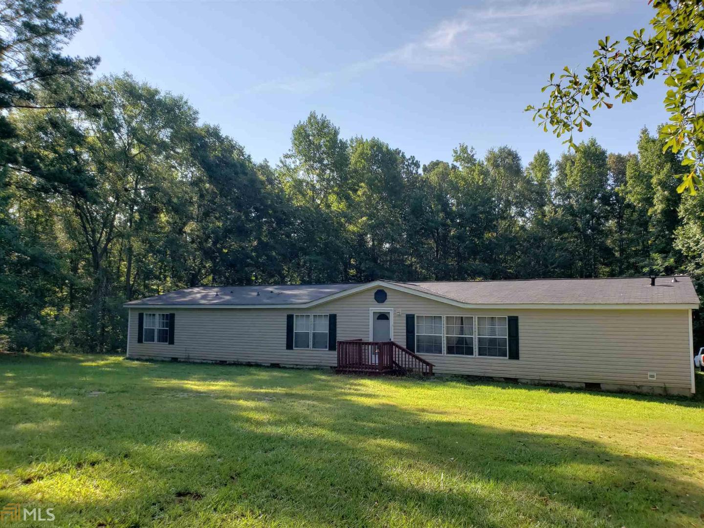 1680 Old Columbus Road Bowdon, GA 30108 - Photo 1 of 1 a front view of a house with a yard garage and outdoor seating