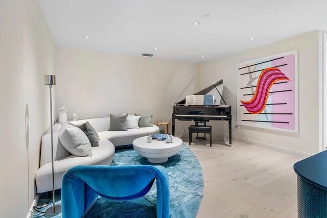 a front view of a building with glass windows and a yard