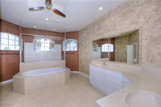 a large spacious bathroom with a granite countertop tub sink and mirror