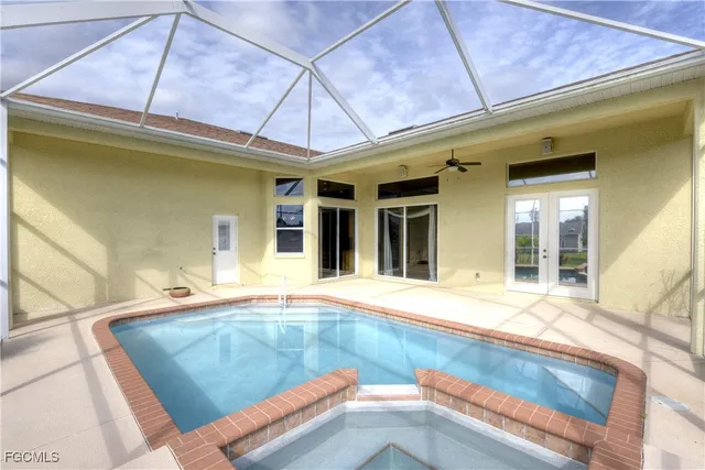 a view of a patio with a table and chairs under an umbrella