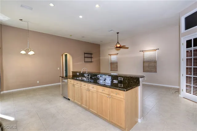 a kitchen with stainless steel appliances granite countertop a sink a stove and a refrigerator