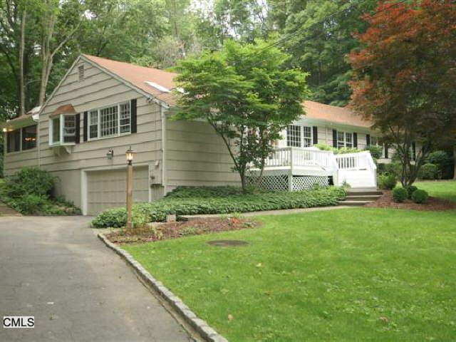 29 Indian Cave Road Ridgefield, CT 06877 - Photo 1 of 1 a front view of a house with a garden and trees