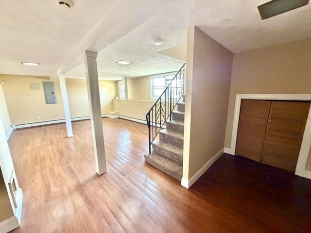 116 Upton Road Waltham, MA 02452 - Photo 20 of 22 wooden floor in an empty room with a window