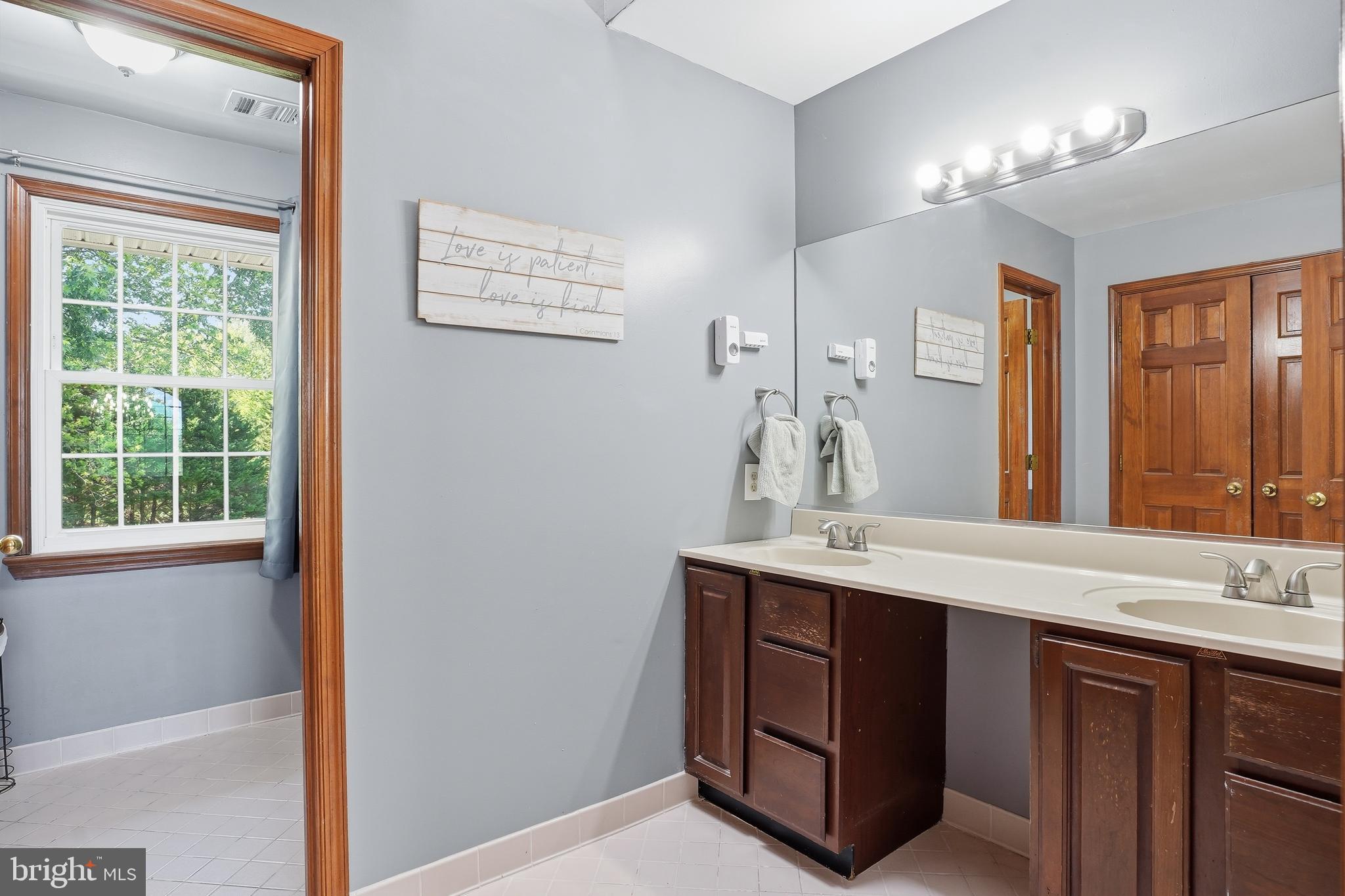 6118 Fishers Station Road Lothian, MD 20711 - Photo 32 of 62 a bathroom with a sink vanity and mirror