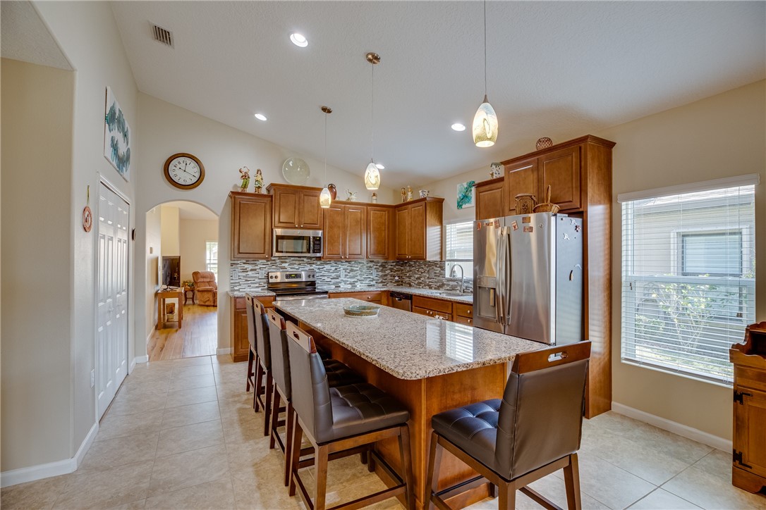 2965 Louetta Circle Melbourne, FL 32901 - Photo 11 of 36 a large kitchen with a table and chairs