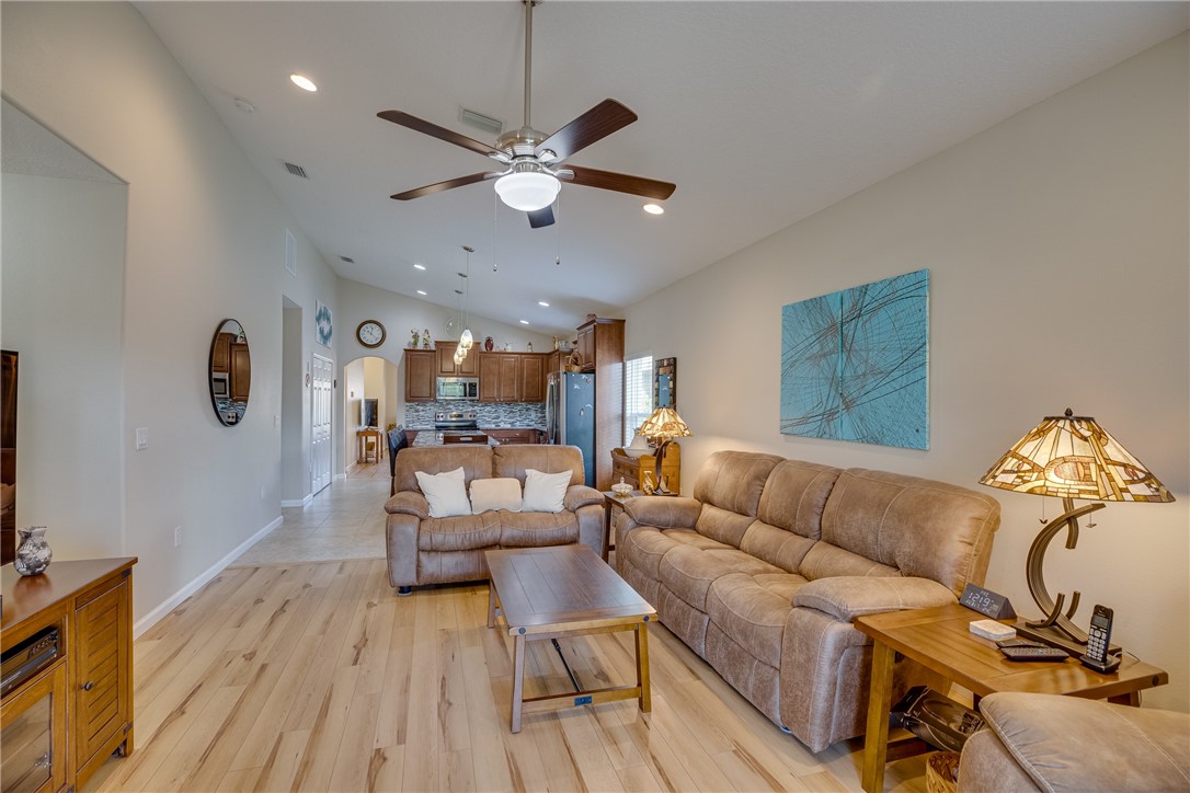 2965 Louetta Circle Melbourne, FL 32901 - Photo 16 of 36 a living room with furniture and a wooden floor