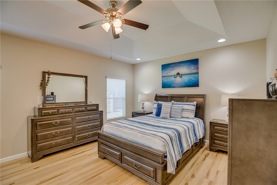 2965 Louetta Circle Melbourne, FL 32901 - Photo 18 of 36 a bedroom with a bed and a chandelier