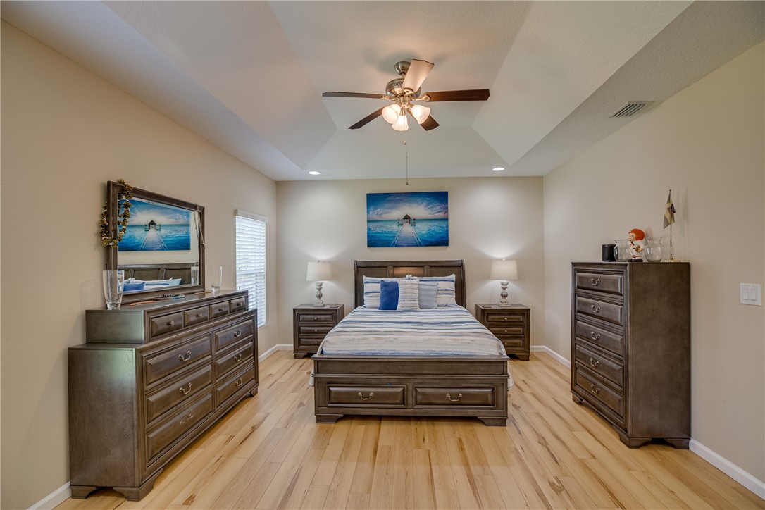 2965 Louetta Circle Melbourne, FL 32901 - Photo 19 of 36 a bedroom with bed and wooden floor