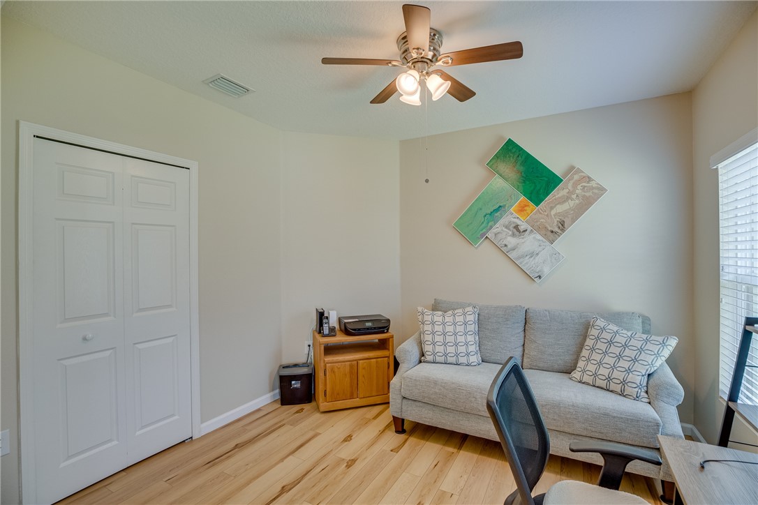 2965 Louetta Circle Melbourne, FL 32901 - Photo 22 of 36 a room with furniture and a wooden floor