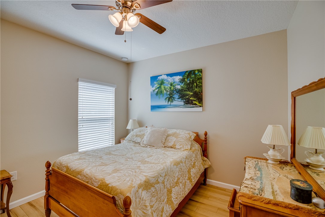 2965 Louetta Circle Melbourne, FL 32901 - Photo 29 of 36 a bedroom with a bed and a chandelier