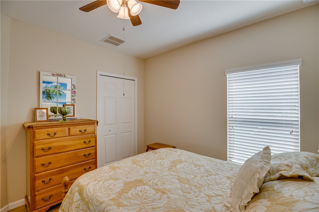 2965 Louetta Circle Melbourne, FL 32901 - Photo 30 of 36 a bedroom with a bed and a dresser in it