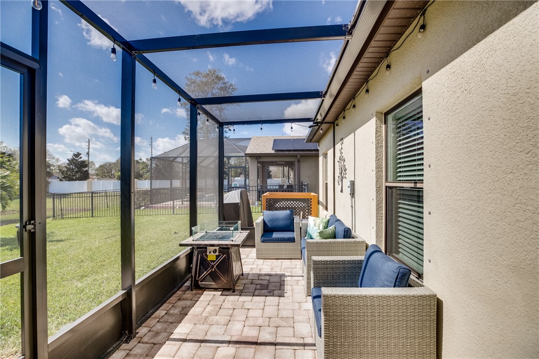 2965 Louetta Circle Melbourne, FL 32901 - Photo 33 of 36 a living room with furniture and a floor to ceiling window