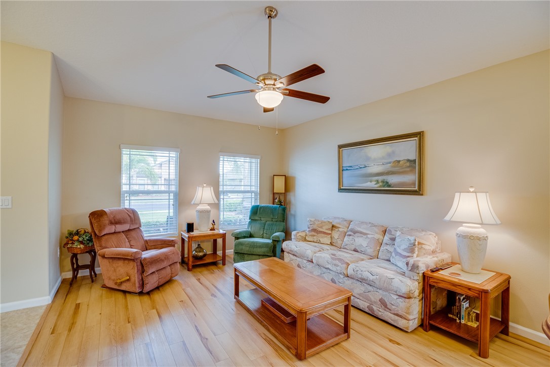 2965 Louetta Circle Melbourne, FL 32901 - Photo 6 of 36 a living room with furniture and a wooden floor