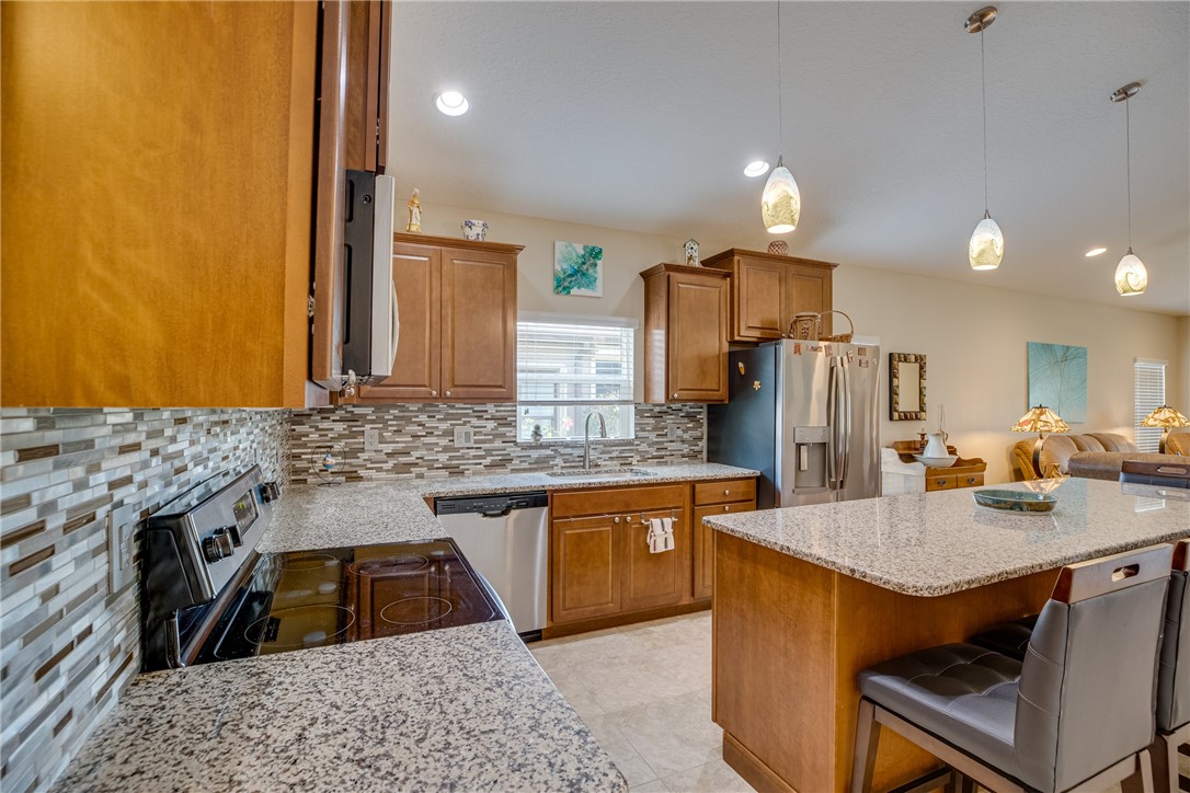 2965 Louetta Circle Melbourne, FL 32901 - Photo 8 of 36 a kitchen with a sink stove and refrigerator