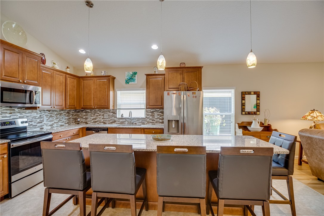 2965 Louetta Circle Melbourne, FL 32901 - Photo 10 of 36 a dining table with chairs and kitchen view