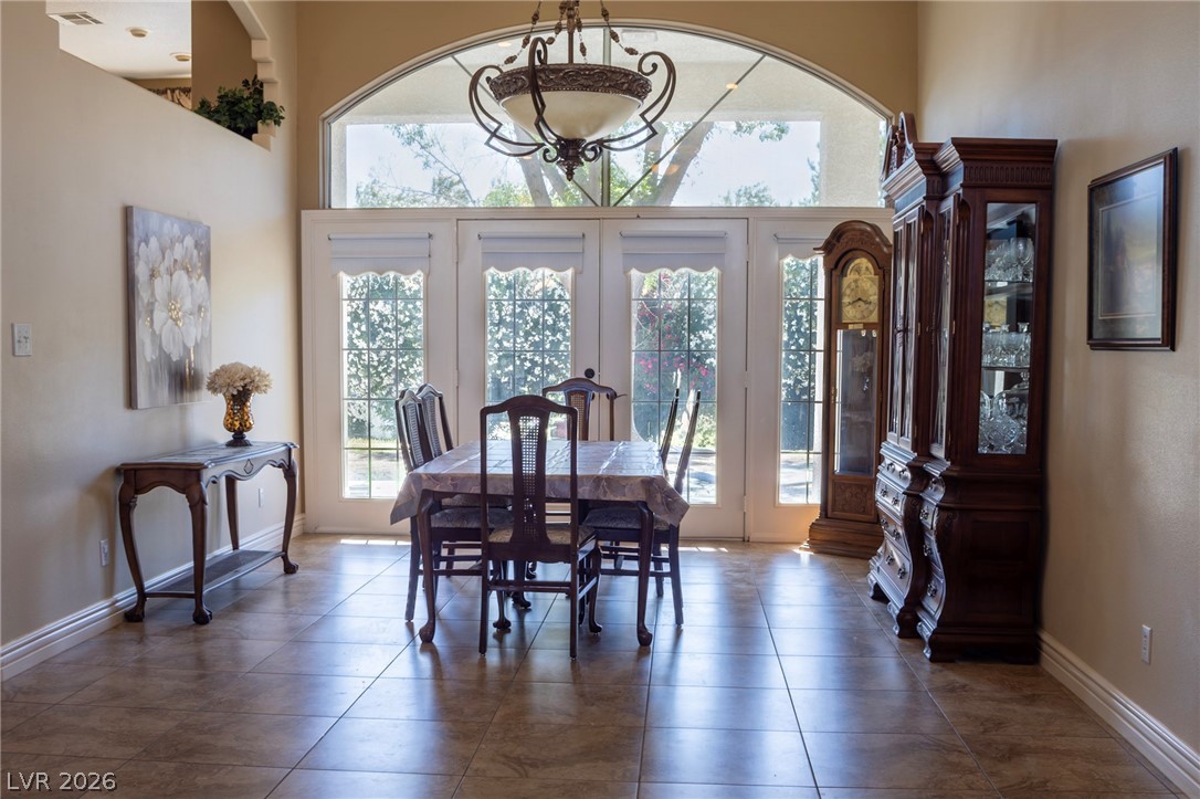 2775 Taylor Street Logandale, NV 89021 - Photo 10 of 41 This spacious dining area features French doors and tile flooring, perfect for gatherings.