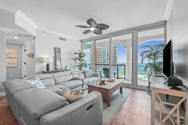 a view of a dining room with furniture and a chandelier
