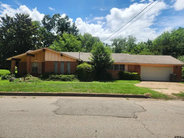 a house that has a tree in front of it