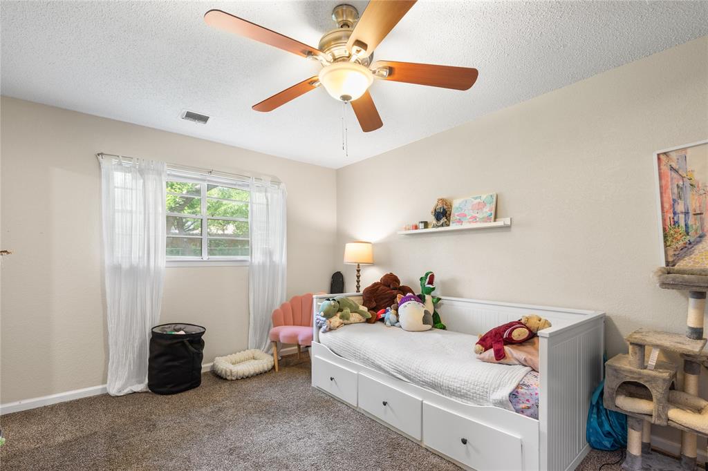613 Edwards Drive Denison, TX 75020 - Photo 13 of 31 a bedroom with a bed and a chandelier