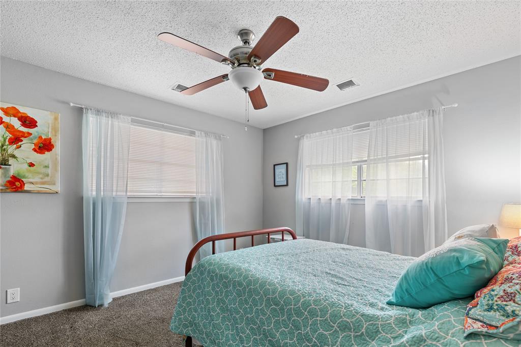 613 Edwards Drive Denison, TX 75020 - Photo 15 of 31 a bedroom with a bed and a chandelier
