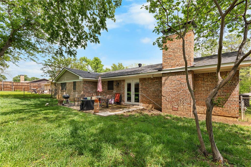 613 Edwards Drive Denison, TX 75020 - Photo 17 of 31 a view of a house with backyard sitting area and garden